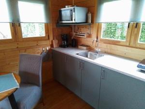 a kitchen with a sink and a counter top at De Wingerd in Bergakker