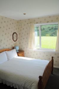 a bedroom with a large bed and a window at Lamont Chalets in Glenelg