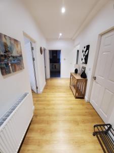 a hallway with a white door and a wooden floor at Purdis Farm - Flat 4 in Bucklesham