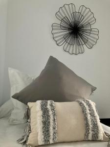 a flower clock on the wall above a pillow at PIEDRA DE LUNA in Merida