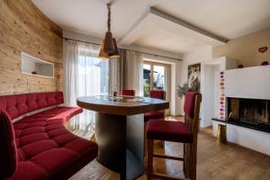 a living room with a red couch and a table at Charmed House in Fiumes