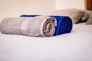 a roll of towels sitting on a bed at Brotteaux in Lyon