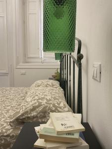 een bed met een tafel met boeken erop bij Il gallo di Eracle - Charming suites & rooms in Termini Imerese
