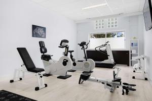 a gym with several exercise equipment in a room at NH Capelle Rotterdam in Capelle aan den IJssel