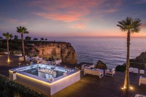 a resort with a pool and a view of the ocean at Tivoli Carvoeiro in Carvoeiro