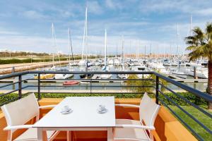 a balcony with a table and chairs and a marina at NH Marina Portimao Resort in Portimão