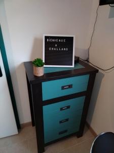 a dresser with a sign on top of it at Studio in Challans