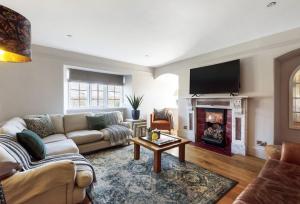 a living room with a couch and a fireplace at Lower Farm in Sherborne