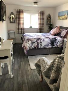 een slaapkamer met een bed en een bureau bij SunKist Lodge in Bridlington