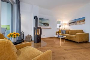 a living room with a wood burning stove in it at Ostseehaus Erika-Maria in Zingst
