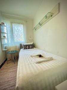a white bed in a room with a window at Perfect Place to Stay self check in-24h-NETFLIX-WIFI in Reşiţa