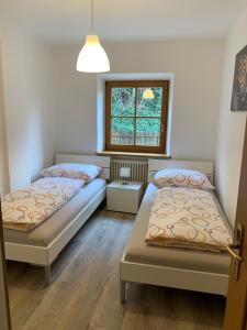 a bedroom with two beds and a window at Appartment Valentin in Chiusa