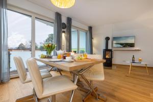 a kitchen and dining room with a table and chairs at Ostseehaus Erika-Maria in Zingst