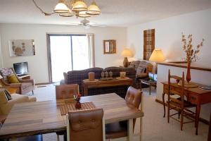 a living room with a table and a dining room at 10328 - 28 Opalo Place in Hot Springs Village
