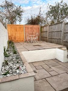 a patio with a table and chairs and a fence at Freshly renovated 2 bedroom Victorian town house. in Hereford