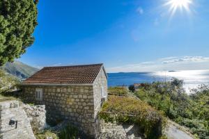 a stone house with a view of the ocean at Villa Soline in Mlini
