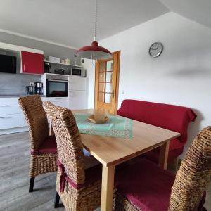 a kitchen and dining room with a wooden table and chairs at Ferienwohnung Adelhardt in Eckersdorf +21 photos