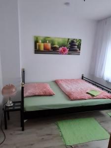 a bedroom with a bed and a window with a picture at Fränkische Rhön Wohnung mit Bergblick ツ in Bad Kissingen