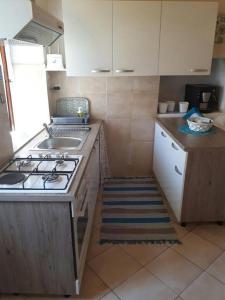 a small kitchen with a stove and a sink at Zora Holiday home in Beli