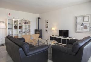 a living room with two couches and a table at Fantastic renovated villa annex in Mijas Costa