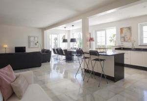a kitchen and living room with a table and chairs at Fantastic renovated villa annex in Mijas Costa