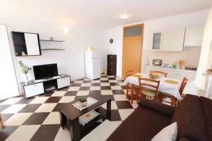 a living room with a couch and a table at Apartments Ana - Kustići in Novalja