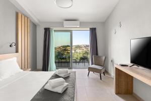a bedroom with a bed and a tv and a balcony at Sarah Luxury Rooms in Syvota +35 photos
