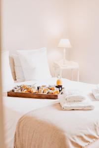 a tray of food sitting on top of a bed at Les Maisons Du Sud in Saint-Tropez