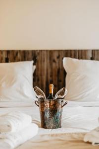 a metal bucket sitting on top of a bed at Les Maisons Du Sud in Saint-Tropez