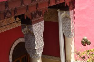 a red building with an ornate design on it at Riad L'Aziza in Marrakesh