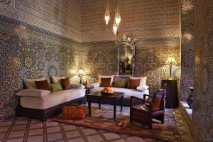 a living room with a couch and a table at Riad L'Aziza in Marrakesh