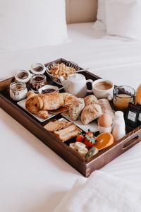 a tray filled with different types of breakfast foods at Les Maisons Du Sud in Saint-Tropez