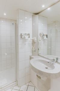 y baño blanco con lavabo y ducha. en Hotel-Restaurant Zum Schwanen en Wermelskirchen