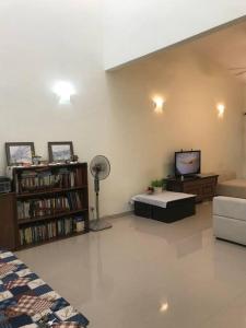 a living room with a couch and a tv at Terrace house near Stulang Laut CIQ Midvalley KSL for 7Pax in Johor Bahru