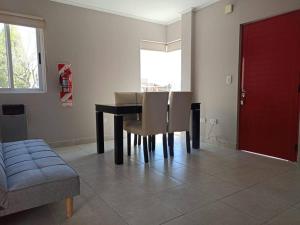 a dining room with a black table and chairs at Lust 270 in Aldea Camarero