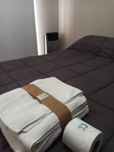 a bed with towels and a roll of toilet paper at Lust 270 in Aldea Camarero