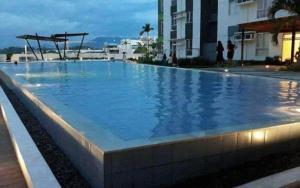 a large swimming pool with blue water at Steff's CONDO 1016 at CENTRIO Tower in Cagayan de Oro