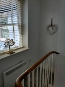 a staircase with a window and a plant on a window sill at Ipswich Town Centre - Apartment 6 in Ipswich