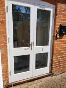 a white door on the side of a brick building at Ipswich Town Centre - Apartment 6 in Ipswich +8 photos