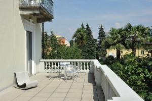 - un balcon avec des chaises et des tables dans un bâtiment dans l'établissement Locarno Youth Hostel, à Locarno