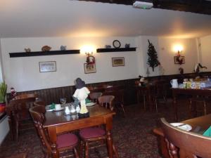 a restaurant with a dining room with tables and chairs at The River Don Tavern and Lodge in Crowle