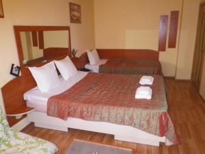 Säng eller sängar i ett rum på Hotel Palitra