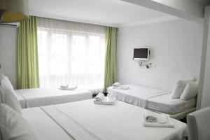 a hotel room with two beds and a window at Yalçın Otel in Antalya +23 photos