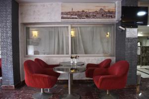 a room with red chairs and a table and a window at Yalçın Otel in Antalya