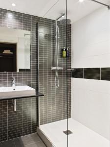 a bathroom with a shower and a sink at Holiday Inn Toulon City Centre, an IHG Hotel in Toulon