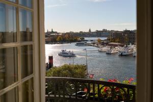 a view from a window of a river with boats at Hotel Diplomat Stockholm in Stockholm