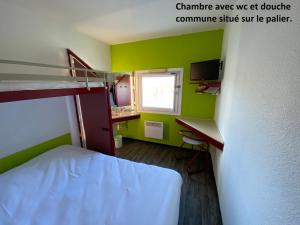 Cette petite chambre comprend des lits superposés et un bureau. dans l'établissement Class'Eco Chambly, à Chambly