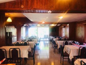 a dining room with rows of tables and chairs at Boss 2 Hotel in Eceabat