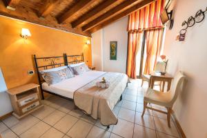 a bedroom with a bed and a table and a chair at Agriturismo Costadoro in Bardolino
