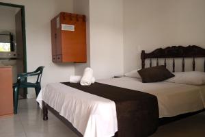 Кровать или кровати в номере Hotel PARAMO LIDERATO